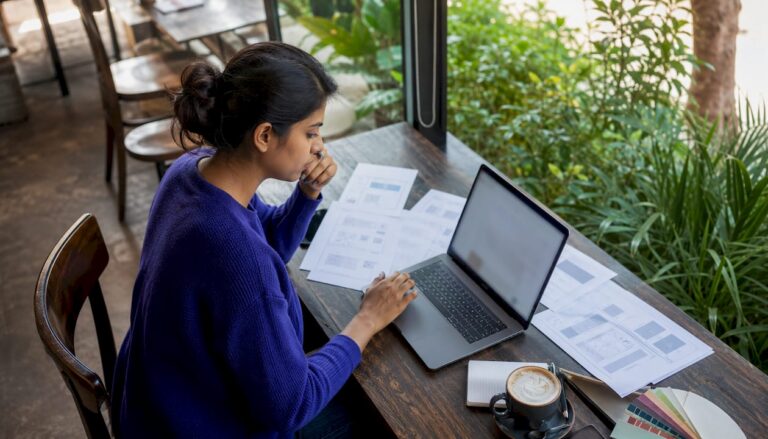 Woman working with AI website builders at home